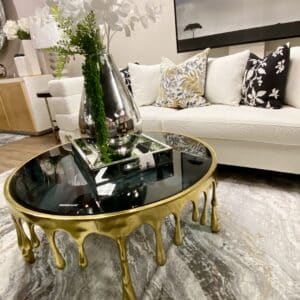 GOLD ALUMINUM DRIP COFFEE TABLE WITH MELTING DESIGNED LEGS AND SHADED GLASS TOP