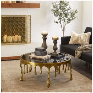 GOLD ALUMINUM DRIP COFFEE TABLE WITH MELTING DESIGNED LEGS AND SHADED GLASS TOP
